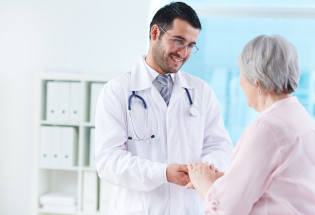 Speaking with patient Confident doctor looking at his senior patient while speaking to her